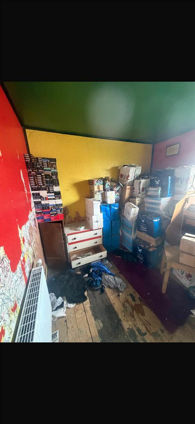Heavily cluttered room before a hoarder house clearance