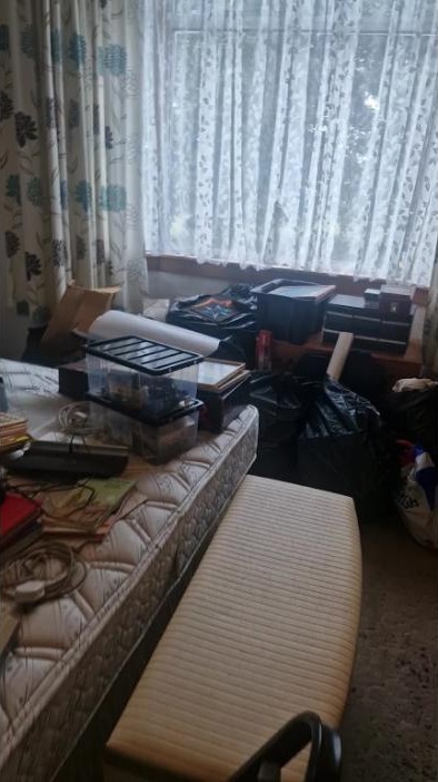 Bedroom full of belongings before house clearance in Airdrie, Scotland